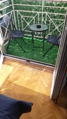 a patio with two chairs and a table in a room at Apartman JELENA M Vrnjačka Banja in Vrnjačka Banja