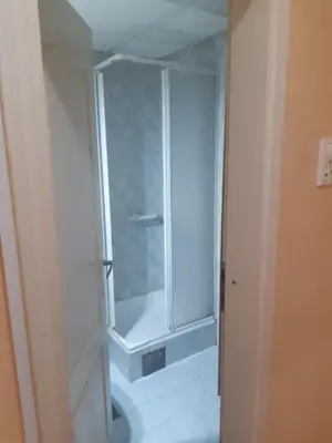 a bathroom with a shower with a glass door at Apartman JELENA M Vrnjačka Banja in Vrnjačka Banja