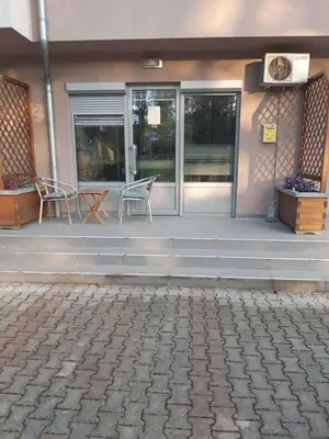 a front porch of a building with a bench on it at Apartman NIKOLIJA Vrnjačka Banja in Vrnjačka Banja