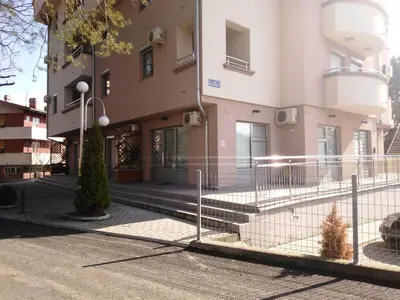 a building with a fence in front of it at Apartman NIKOLIJA Vrnjačka Banja in Vrnjačka Banja