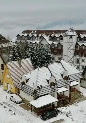 a group of houses with snow covered roofs at Apartmani Vidatela Kopaonik in Kopaonik