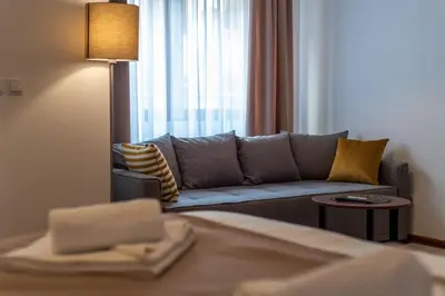a living room with a couch and a window at Apartman EROS in Vrnjačka Banja