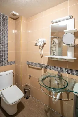 a bathroom with a toilet and a sink and a mirror at Apartman EROS in Vrnjačka Banja