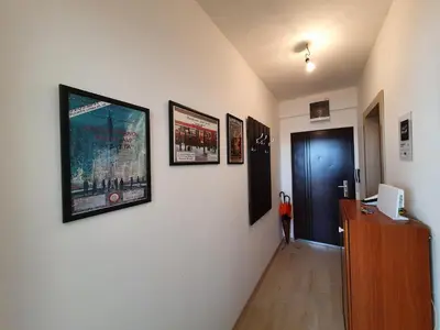 a hallway with pictures on the walls of a room at Apartman Aleksic in Niš