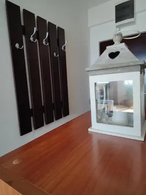 a mirror on a wooden floor next to some doors at Apartman Aleksic in Niš