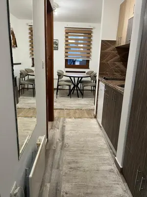 a kitchen and dining room with a table and chairs at Vila Suri Centar in Kopaonik