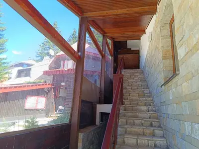a staircase leading up to a building with a window at Vila Suri Centar in Kopaonik