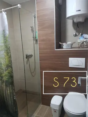a bathroom with a toilet and a glass shower at Apartments S73&S74 Milmari Resort, Kopaonik in Kopaonik