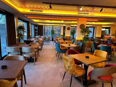 a restaurant with tables and chairs in a room at Apartments S73&S74 Milmari Resort, Kopaonik in Kopaonik