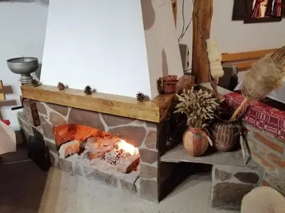a fireplace in a living room with a fire place at Etno kuca Nikolov in Dimitrovgrad
