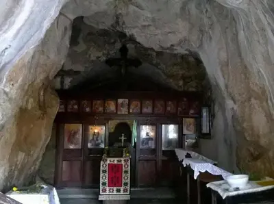 a church with tables and chairs in a cave at Etno kuca Nikolov in Dimitrovgrad
