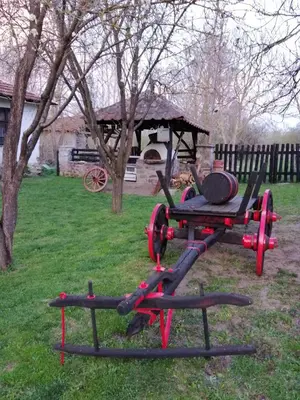 a picnic table in the grass with a grill at Etno kuca Nikolov in Dimitrovgrad
