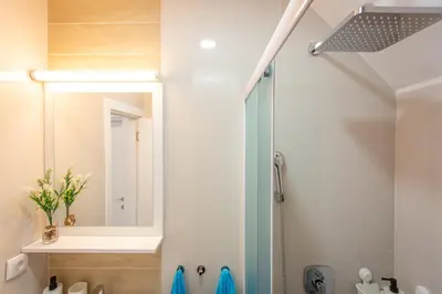 a bathroom with a shower and a mirror at Apartments View Dvori E25 in Kopaonik