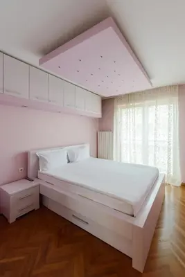 a large white bedroom with a large bed and a window at Hotel Crystal - Depandans in Kraljevo
