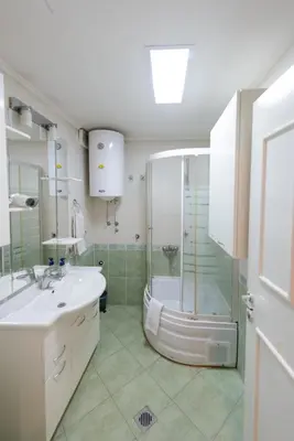 a bathroom with a shower and a sink and a tub at Hotel Crystal - Depandans in Kraljevo