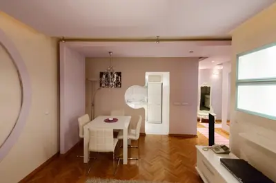 a dining room with a white table and chairs at Hotel Crystal - Depandans in Kraljevo
