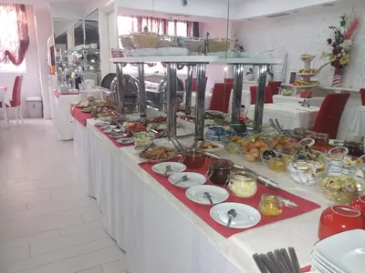 a buffet line with plates of food on it at Hotel Crystal - Depandans in Kraljevo