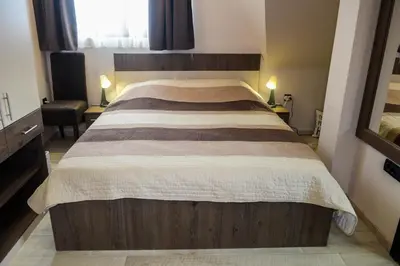a bedroom with a large bed in a room at Apartman Milmari Idila in Kopaonik
