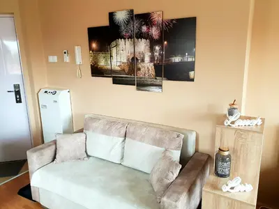 a living room with a couch and some pictures on the wall at SOGNI D'ORO in Niš