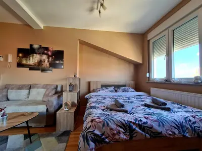 a bedroom with a bed and a couch at SOGNI D'ORO in Niš