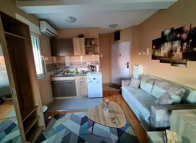 a living room with a couch and a table at SOGNI D'ORO in Niš