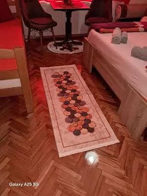 a room with two beds and a chessboard on the floor at Vila Mala Evropa in Leskovac