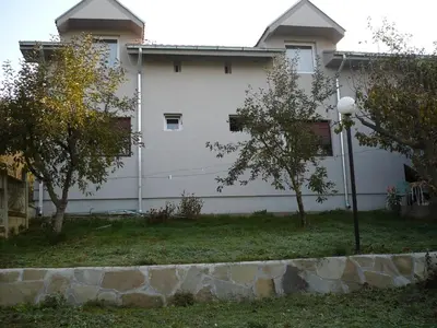 a white building with trees in front of it at Motel Stara Vrba in Kuršumlija