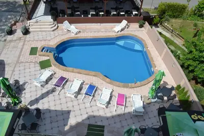 an overhead view of a swimming pool with lounge chairs at Guesthouse Vila DND in Niška Banja