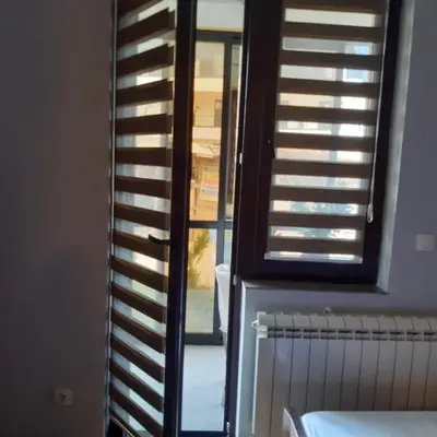 a room with a window with shutters and a radiator at Studio Jolly Kop Jana 2 in Kopaonik