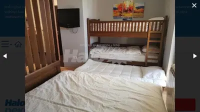 two bunk beds in a room with a tv at Studio Jolly Kop Jana 2 in Kopaonik