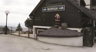 a building with a fire hydrant on the side of it at Studio Jolly Kop Jana 2 in Kopaonik