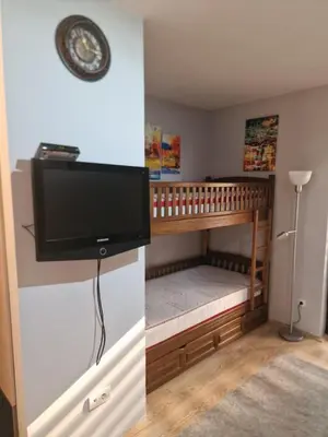 a room with a crib with a flat screen tv at Studio Jolly Kop Jana 2 in Kopaonik