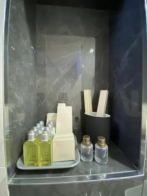 a shelf with several bottles of essential oils on it at Majestic Apartment in Jagodina