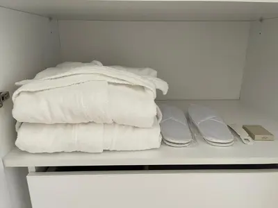 a group of towels are stacked on a shelf at Majestic Apartment in Jagodina