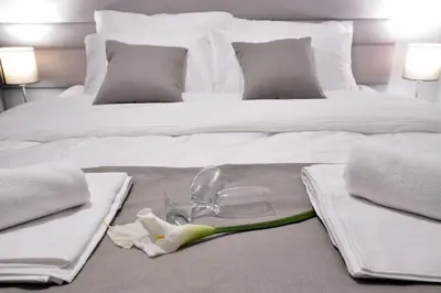 a bed with towels and a pair of glasses on it at Apartman DiamondLux Vrnjacka Banja in Vrnjačka Banja