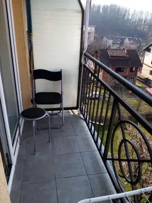a chair sitting on a balcony with a view at Apartman Gordana in Vrnjačka Banja