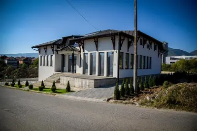 a small white building on the side of a road at Prenociste ADRIA in Vranje