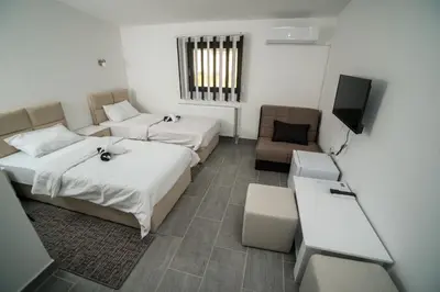 a hotel room with two beds and a television at Prenociste ADRIA in Vranje