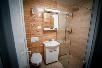 a bathroom with a toilet and a sink and a shower at Prenociste ADRIA in Vranje