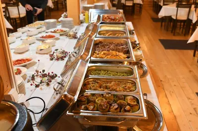 a buffet line with many different types of food at The Nest Apartman, Župa Wellness & Spa Kopaonik in Kopaonik