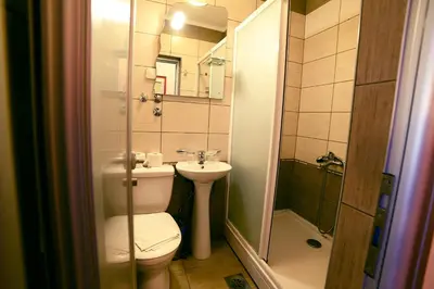 a bathroom with a toilet and a sink and a shower at Dental apartman in Vrnjačka Banja