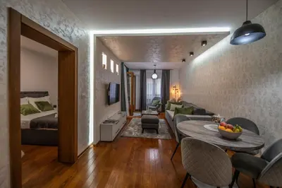 a room with a bed and a living room at NOVAK apartman in Vrnjačka Banja