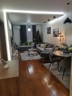 a living room with a couch and a christmas tree at NOVAK apartman in Vrnjačka Banja