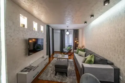 a living room with a couch and a tv at NOVAK apartman in Vrnjačka Banja