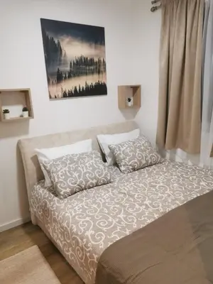 a bed with two pillows on it in a room at Hedonic in Kopaonik
