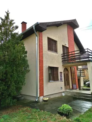 a house with a balcony on top of it at Vila Milica in Kraljevo