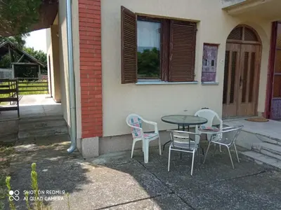 a table and chairs sitting outside of a building at Vila Milica in Kraljevo