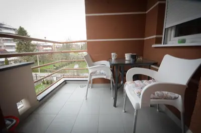 a balcony with a table and chairs and a view at Apartman La Casa Di Elena in Vrnjačka Banja
