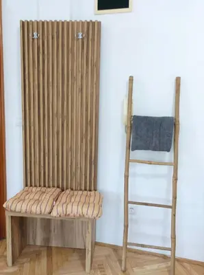 a wooden bench and a ladder in a room at Apartman Rajska Banja in Vrnjačka Banja