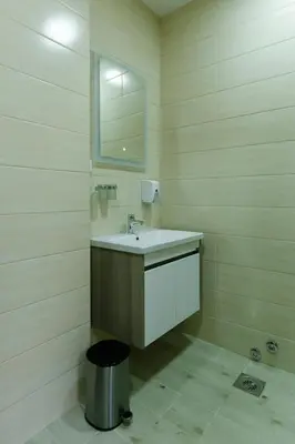 a bathroom with a sink and a mirror at Apartmani Veselinović in Vrnjačka Banja